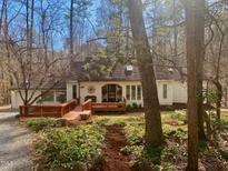Charming exterior showcasing a cozy front porch and beautiful, natural surroundings at 115 Stone Edge, Pittsboro, NC 27312