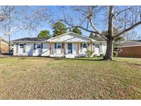 Charming single-story home with brick facade, covered porch, and mature trees at 1246 Nc 27, Benson, NC 27504