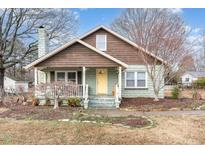 Charming home featuring light-green brick, wood siding, chimney, front porch and meticulously maintained landscaping at 209 E Winston St, Youngsville, NC 27596