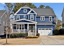 Beautiful two-story home with a welcoming front porch, two-car garage, and well-maintained landscaping at 2540 Glade Mill Ct, Fuquay Varina, NC 27526