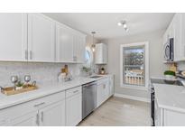 Bright kitchen featuring white cabinets, stainless steel appliances, and quartz countertops at 4610 Lemon Heights Dr, Sanford, NC 27332