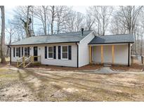 Charming single-story home featuring black shutters and trim, complemented by a well-maintained yard at 5635 Paragon Cir, Durham, NC 27712