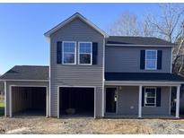 Two-story home with gray siding, black shutters, and attached two-car garage at 605 Wondertown Dr, Dunn, NC 28339