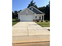 Charming one-story home with a two-car garage, easy to maintain yard and concrete driveway at 7369 Pilatus Ave, Spring Hope, NC 27882