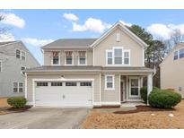 Charming two-story home with neutral siding, white trim, and an attached two-car garage at 907 Pleasant Colony Dr, Knightdale, NC 27545