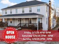 Charming two-story home featuring a covered front porch and classic architectural details at 121 Hamilton St, Henderson, NC 27536