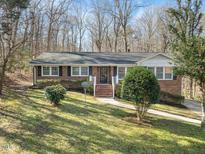 Charming brick home with well-maintained lawn and landscaped front yard at 123 Stedwick Pl, Durham, NC 27712