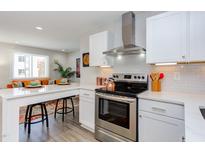 Modern kitchen features stainless steel appliances, white cabinets, and a breakfast bar perfect for entertaining at 1309 Hudson Ave # D17, Durham, NC 27705