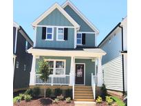 Charming two-story home featuring a cozy front porch and a professionally landscaped yard at 1905 Plott Balsam Dr, Wendell, NC 27591