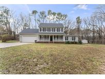 Charming two-story home with white picket fence, attached garage, and large front yard at 2015 Pratt Cir, Franklinton, NC 27525
