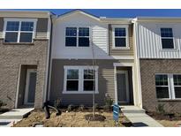 New two-story townhome featuring mixed siding, modern windows, and professional landscaping at 2060 Glen Crossing Dr, Durham, NC 27704