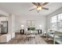 Bright living room with neutral decor, modern furnishings, and a stylish ceiling fan at 240 Amber Acorn Ave, Raleigh, NC 27603