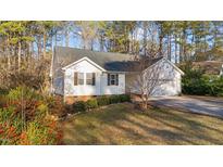 Charming one-story home with light siding, black shutters, manicured lawn, and mature landscaping at 276 Sagamore Dr, Louisburg, NC 27549