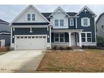 Charming two-story home featuring a two-car garage and a welcoming front porch at 3529 Bailey Lk Dr, Fuquay Varina, NC 27526