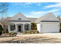 Charming single-story home with a well-manicured front yard, attached two-car garage, and inviting front porch at 627 Aylestone Dr, Cary, NC 27519