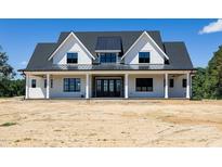 Stunning new construction home with a welcoming front porch and modern farmhouse design at 6509 Zebulon Rd, Wake Forest, NC 27587