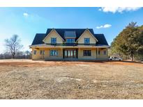 Spacious two-story house with black trim and a metal roof situated on a large lot at 6509 Zebulon Rd, Wake Forest, NC 27587