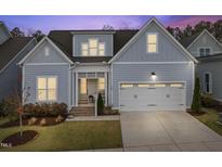 Charming two-story home with a well-maintained lawn, driveway, and an attached two-car garage at 729 Daniel Ridge Rd, Wendell, NC 27591