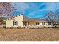 Charming single-story home with a covered front porch and well-maintained landscaping at 7409 Blalock Rd, Bahama, NC 27503