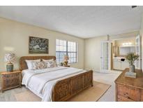 Bright bedroom boasts a wooden bed frame and an attached bathroom for added convenience and privacy at 7712 Falcon Rest Cir, Raleigh, NC 27615