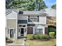 Inviting townhouse with charming brick accents and well-maintained landscaping at 7712 Falcon Rest Cir, Raleigh, NC 27615