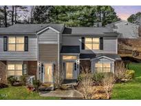 Traditional style townhome with neutral siding, black shutters, and manicured lawn at 7712 Falcon Rest Cir, Raleigh, NC 27615