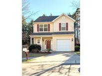 Charming two-story home with a well-manicured front yard and inviting curb appeal at 813 Woodside Park Ln, Durham, NC 27704