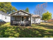 Charming single-story home featuring a cozy front porch with black railings at 816 Elizabeth St, Burlington, NC 27217