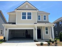 Charming two-story home with attached two-car garage and covered front porch with craftsman-style columns at 89 Willow Cameron Way, Angier, NC 27501