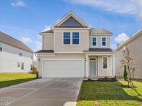 Charming two-story home with attached two-car garage and well-manicured lawn at 89 Willow Cameron Way, Angier, NC 27501