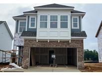 New construction home featuring a brick facade, attached garage, and modern architectural details at 98 Willow Cameron Way, Angier, NC 27501