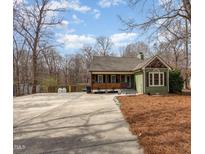 Charming exterior view of a craftsman home with a large concrete driveway at 111 Preakness Dr, Archer Lodge, NC 27527