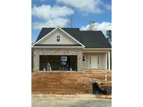 Charming single-story home featuring a stone facade garage and a welcoming front entrance at 235 Meadowbark Bnd # 26, Garner, NC 27529