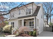 Charming two-story home with a inviting front porch and landscaped yard at 312 Bickett Blvd, Raleigh, NC 27608
