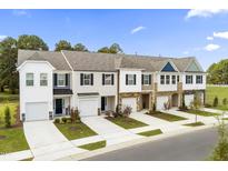 Beautiful new townhomes boast varied exterior colors, front-entry garages, and well-kept landscaping at 341 Church St # 67, Wendell, NC 27591