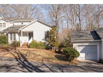 Exterior shot of a house and garage with a landscaped front and a brick stairway leading to the front door at 475 Beechmast, Pittsboro, NC 27312