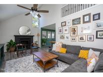 Bright living room features a vaulted ceiling, stylish furniture, and modern decor at 5417 Walton Hill Rd, Knightdale, NC 27545