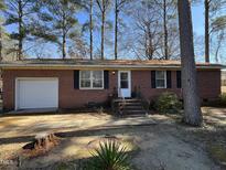 Charming one-story brick home with front yard, single-car garage, and classic architectural details at 833 Ward St, Smithfield, NC 27577