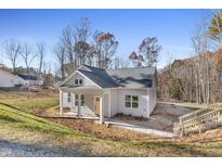 Charming new build featuring a welcoming front porch and landscaped surroundings at 873 Jasmine Rd, Fuquay Varina, NC 27526