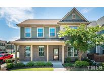 Charming two-story home with a brick facade, covered porch and mature landscaping at 9200 Torre Del Oro Pl, Raleigh, NC 27617