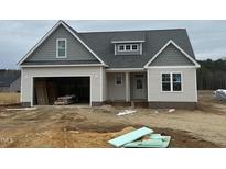 New construction home featuring a two-car garage and covered front entry at 9246 Bear Run Ln, Middlesex, NC 27557