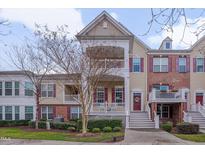 Charming townhome with double porches, brick accents, and beautifully landscaped front yard at 10510 Sablewood Dr # 114, Raleigh, NC 27617