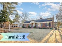 Charming brick home featuring a well-manicured lawn and traditional architectural details at 1107 S 2Nd St, Smithfield, NC 27577
