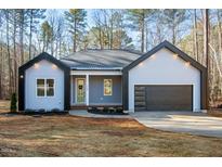 New construction home with gray siding, black accents, and an attached garage at 112 Fort Dr, Louisburg, NC 27549