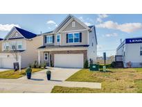 Charming two-story home with a two-car garage and a beautifully landscaped front yard at 118 N Finley Landing Pkwy # 3, Smithfield, NC 27577