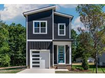 Charming two-story home with modern design, stylish blue door and a one car garage at 140 E End Ave # 2, Durham, NC 27703