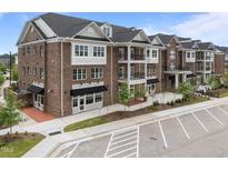 Beautiful brick building exterior featuring black awnings and convenient parking spaces at 1400 Gathering Park Cir # 202, Cary, NC 27519