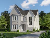 Striking two-story home showcases modern architecture and manicured landscaping, framed by mature trees against a blue sky at 1529 Salem Church Rd, Apex, NC 27523