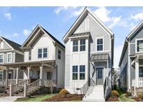 Charming two-story home with light-blue siding, white trim, and a welcoming front entrance at 1662 Piney Fls Dr, Wendell, NC 27591
