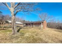 Charming brick home with a covered porch and carport on a spacious lot with mature trees at 178 Medford Oakley Rd, Rougemont, NC 27572